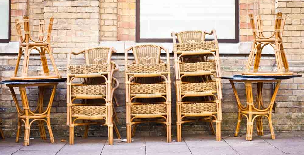 Stacked,Tables,And,Chairs,Outside,A,Cafe,In,A,Town